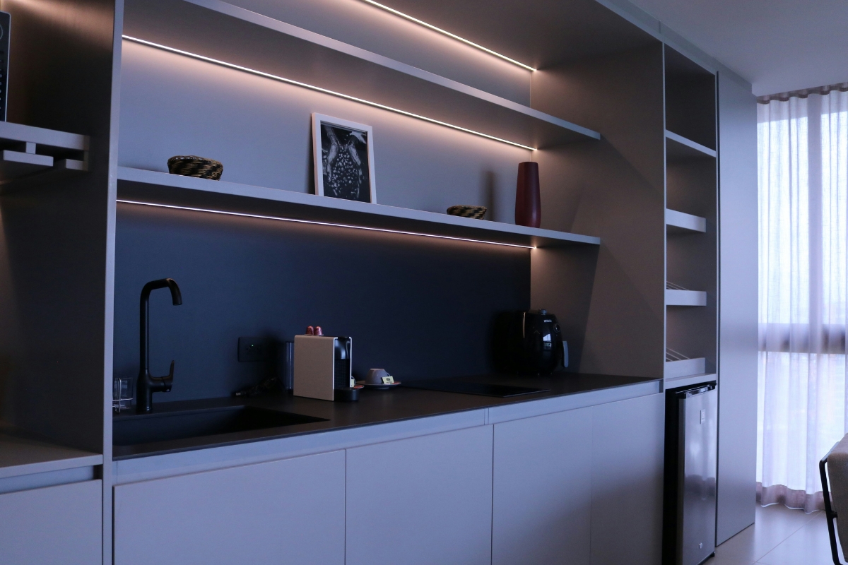 Kitchen wall with open shelves and hooks combining storage and display for a stylish and organized functional kitchen design