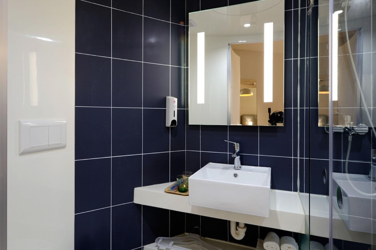 Japandi bathroom with warm beige walls and natural wood vanity