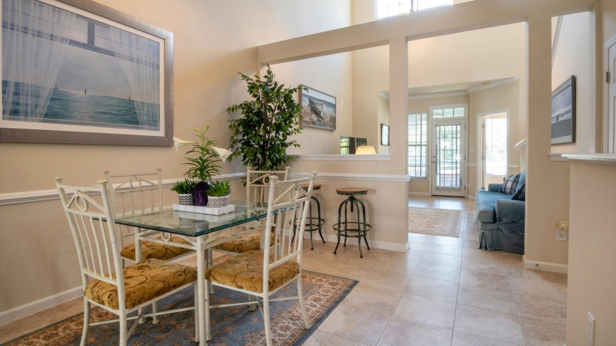 Open-concept dining room with modern table, pendant lighting, and seamless living room flow