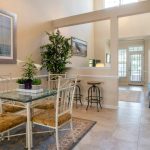 Open-concept dining room with modern table, pendant lighting, and seamless living room flow