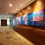 Oversized abstract wall art above modern living room sofa creating a bold focal point