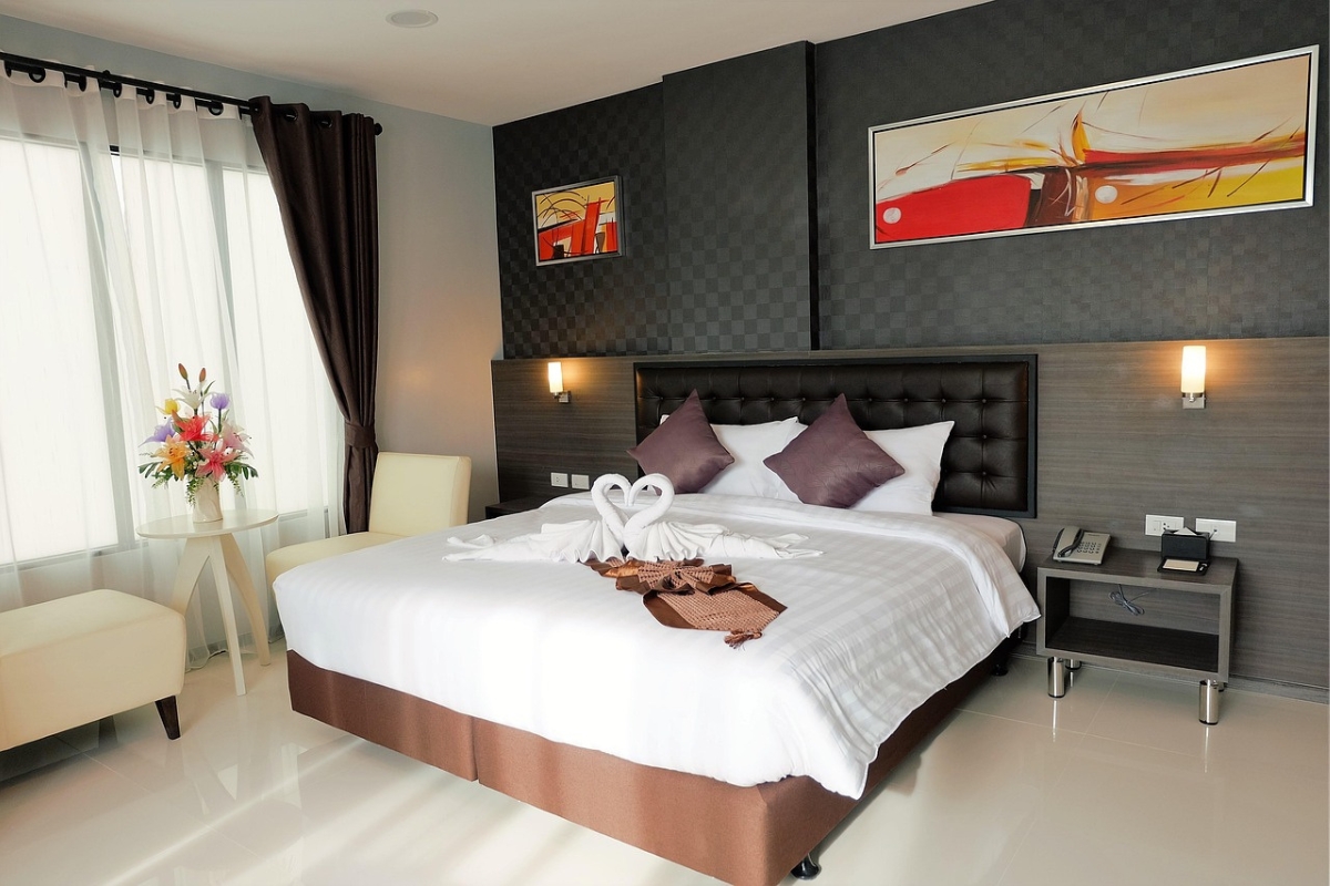 Modern bedroom with painted arch accent wall behind bed in soft neutral tone creating stylish focal point 2026