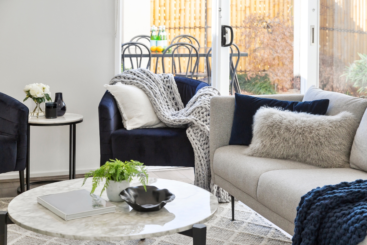 Living room styling with varied height and scale for visual balance