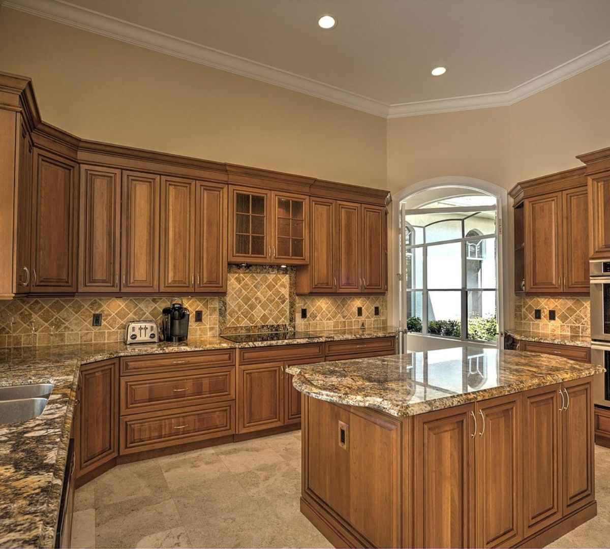 Rounded corner kitchen cabinets in a small apartment, providing safe, space-saving storage and smooth edges for improved movement and usability.