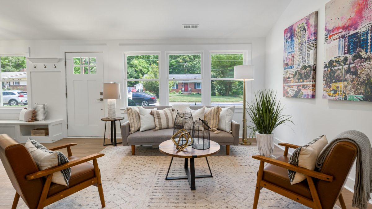 Bright and cozy living room with light fabrics, pastel accents, indoor plants, and natural textures creating a fresh spring home transition vibe.