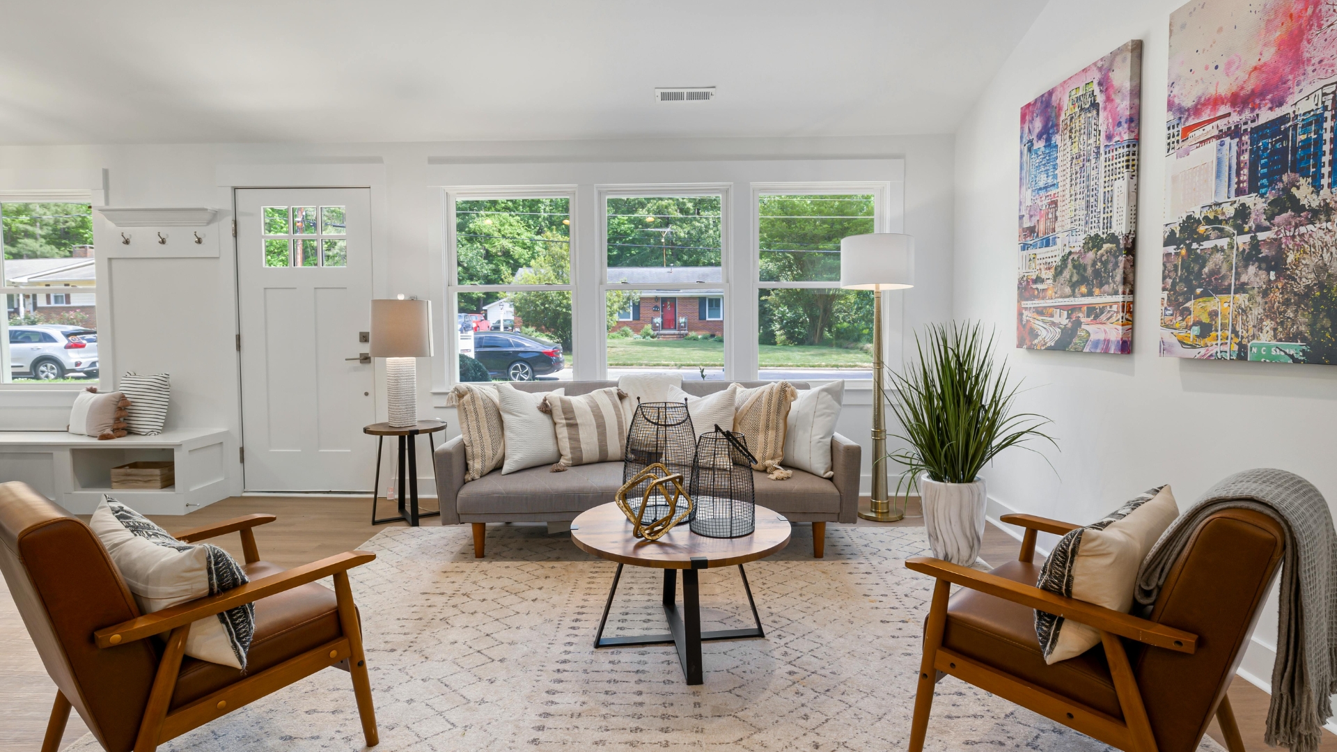 Bright and cozy living room with light fabrics, pastel accents, indoor plants, and natural textures creating a fresh spring home transition vibe.
