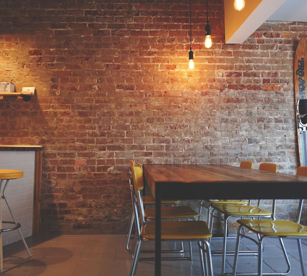 Semi-circular wall-mounted drop table in small apartment dining area, foldable for space-saving, providing functional and versatile seating.