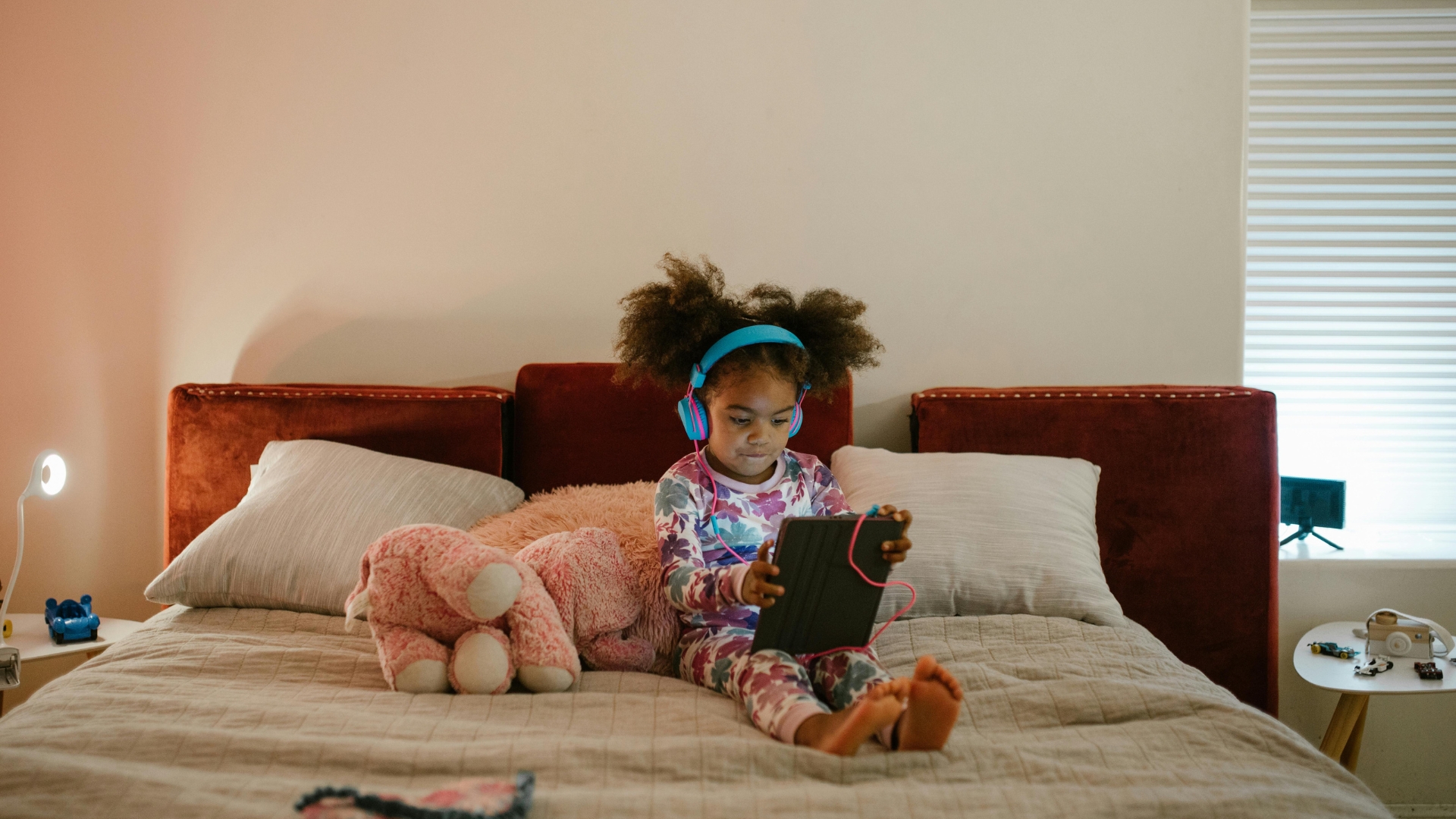 Modern kids room with soft and safe styling featuring neutral walls, cozy bedding, rounded furniture, plush rugs, and child-friendly decor for comfort and simplicity