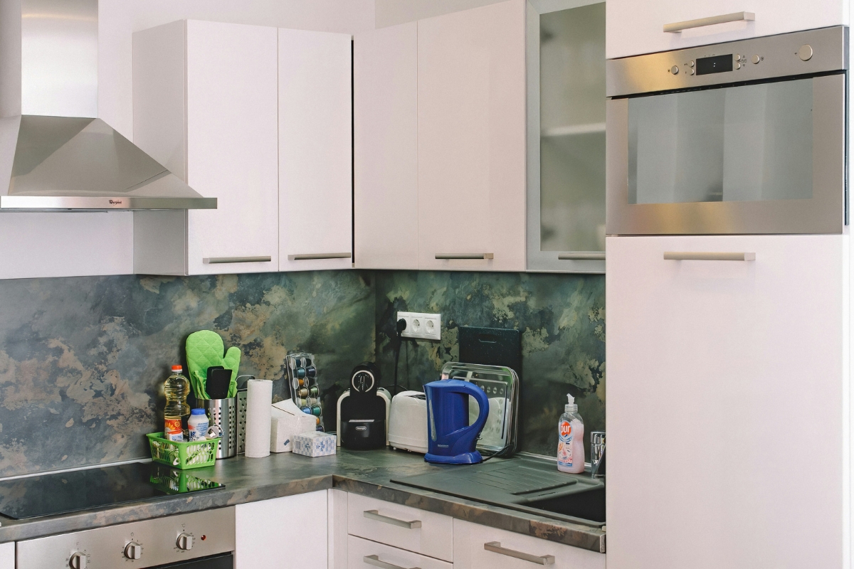 Modern kitchen wall with floating shelves and hooks designed based on user needs for practical and stylish storage