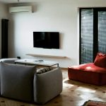 Airy summer living room with light curtains and neutral decor Heat-friendly summer home layout with natural light and minimal furniture