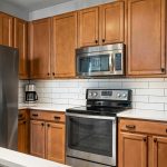 Textured kitchen wall with modern tiles and wooden panels creating a premium, stylish kitchen interior design look
