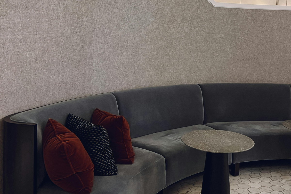 Curved sofa in small living room creating cozy and open spaceRound coffee table in compact modern apartment