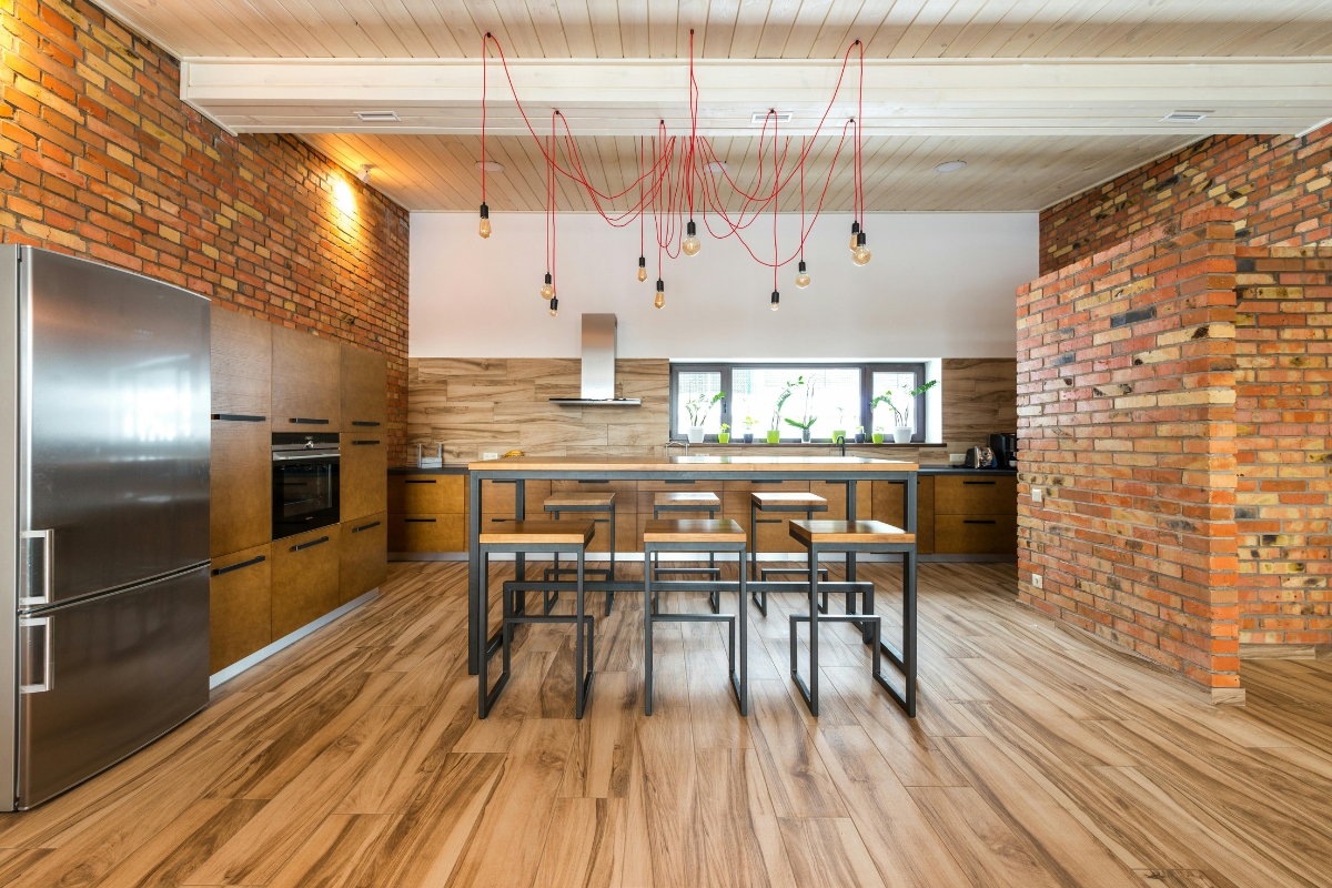 Kitchen accent wall with under-cabinet lighting and pendant lights highlighting bold colors and patterned backsplash for a stylish kitchen interior