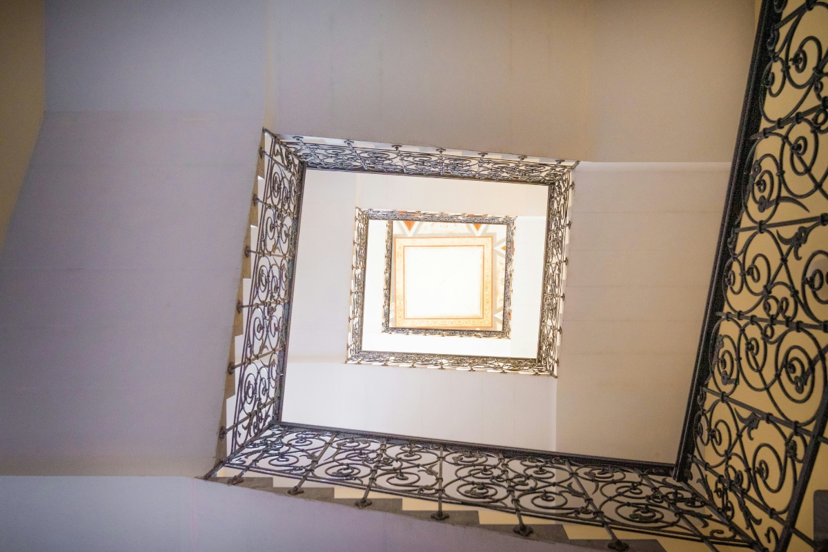 Bedroom with vertical mirror leaning against wall to enhance low ceiling height