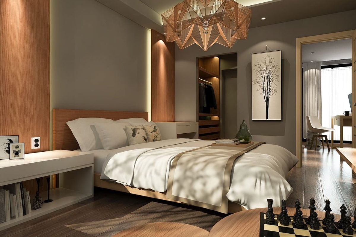 Modern bedroom with vertical wood slat panel accent wall behind bed creating warm textured design 2026