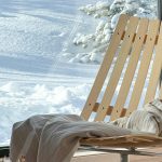 Cozy winter living room with warm layered blankets and soft ambient lighting