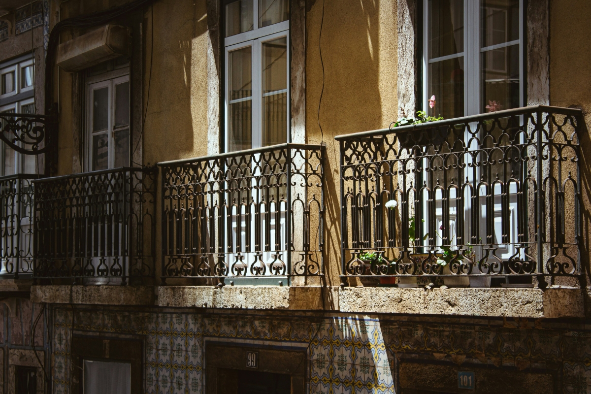 decorated balcony railing with plants and lights for summer