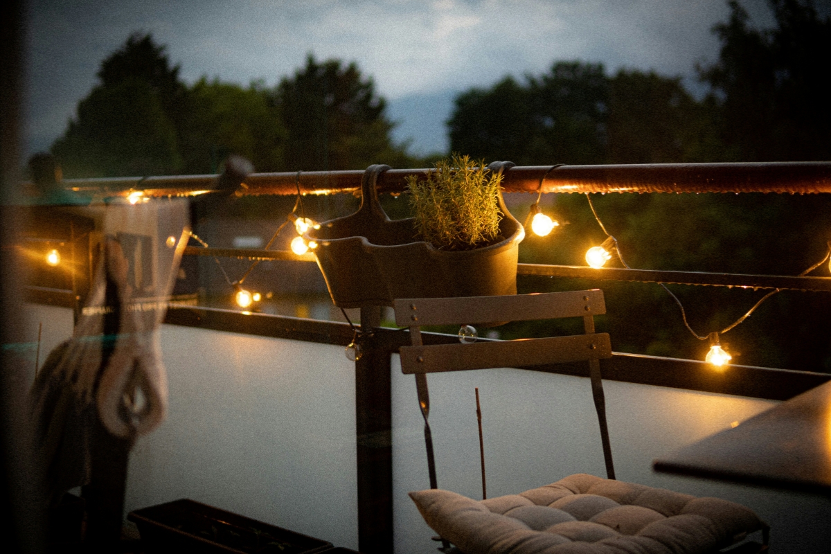 string lights decorating a cozy summer balcony
