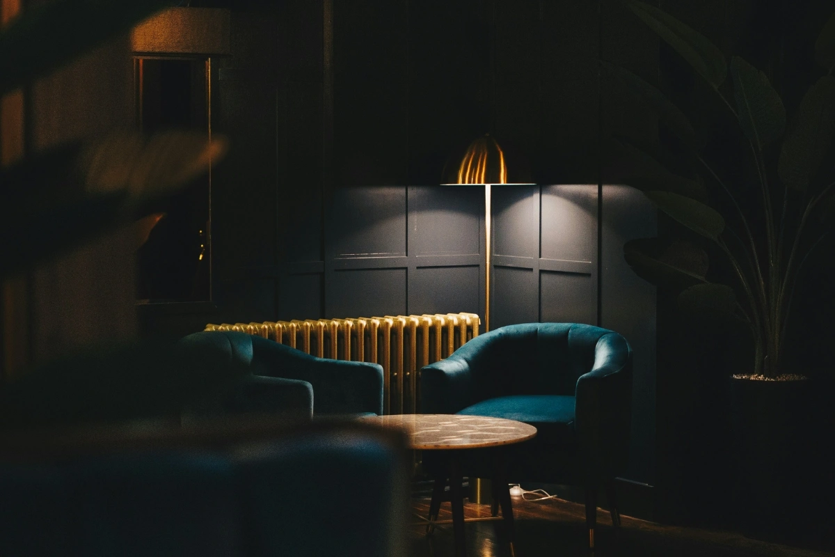Emotional Interior Design moody living room with dark colors and warm lighting