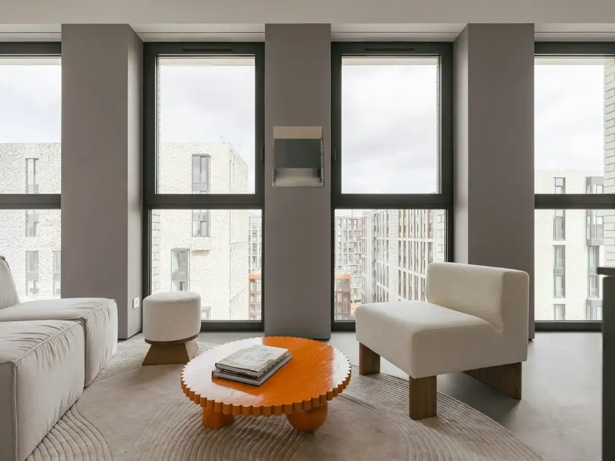 Cozy studio apartment with layered lighting and vertical shelves 