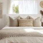 Boho Bedroom Ideas with warm earthy tones, layered bedding, natural textures, plants, and cozy bohemian decor