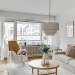 Scandinavian home decor ideas for a cozy modern living room with natural wood, soft colors, cozy textures, and simple furniture